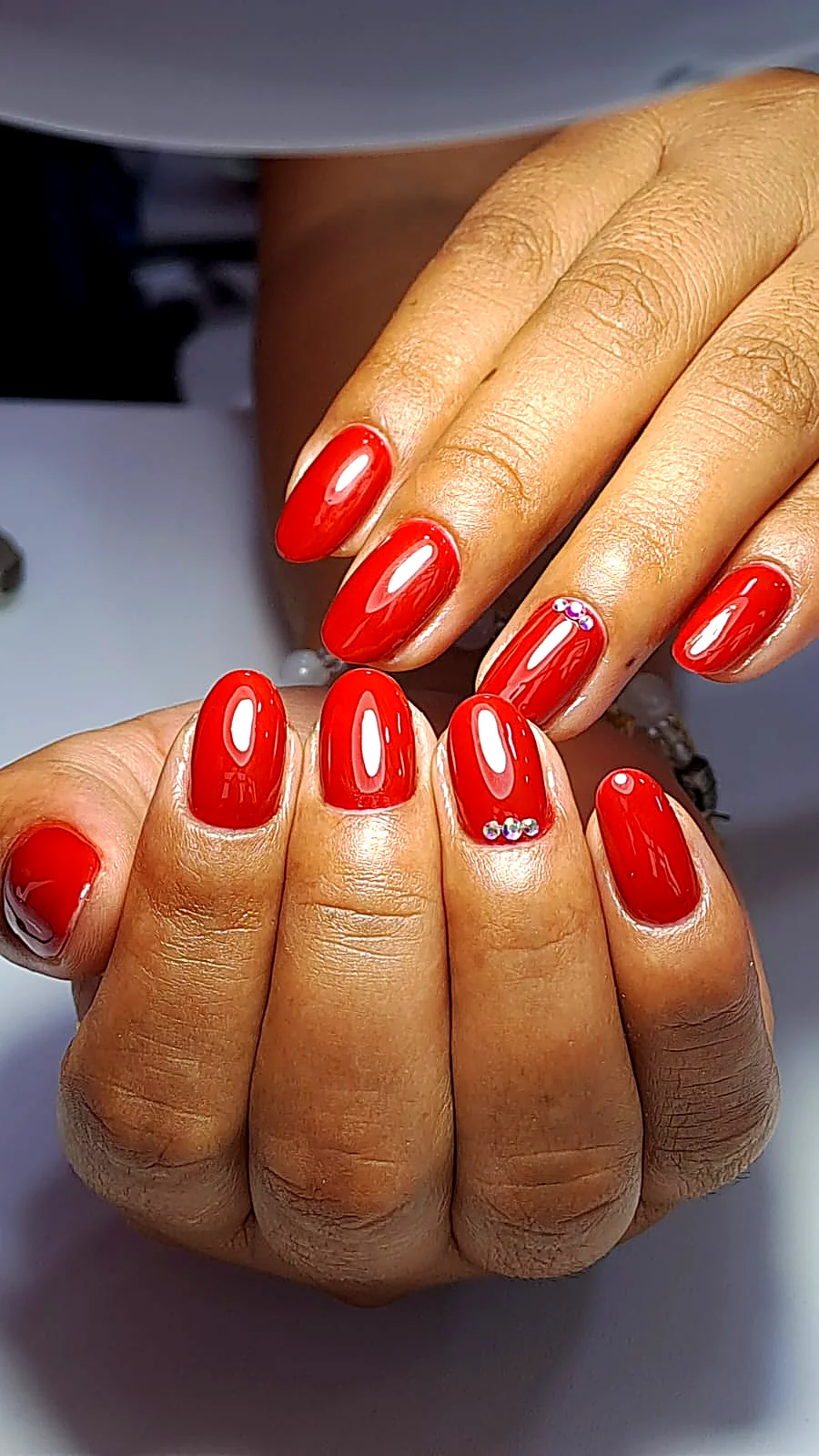 Uñas rojo intenso con cristales incrustados